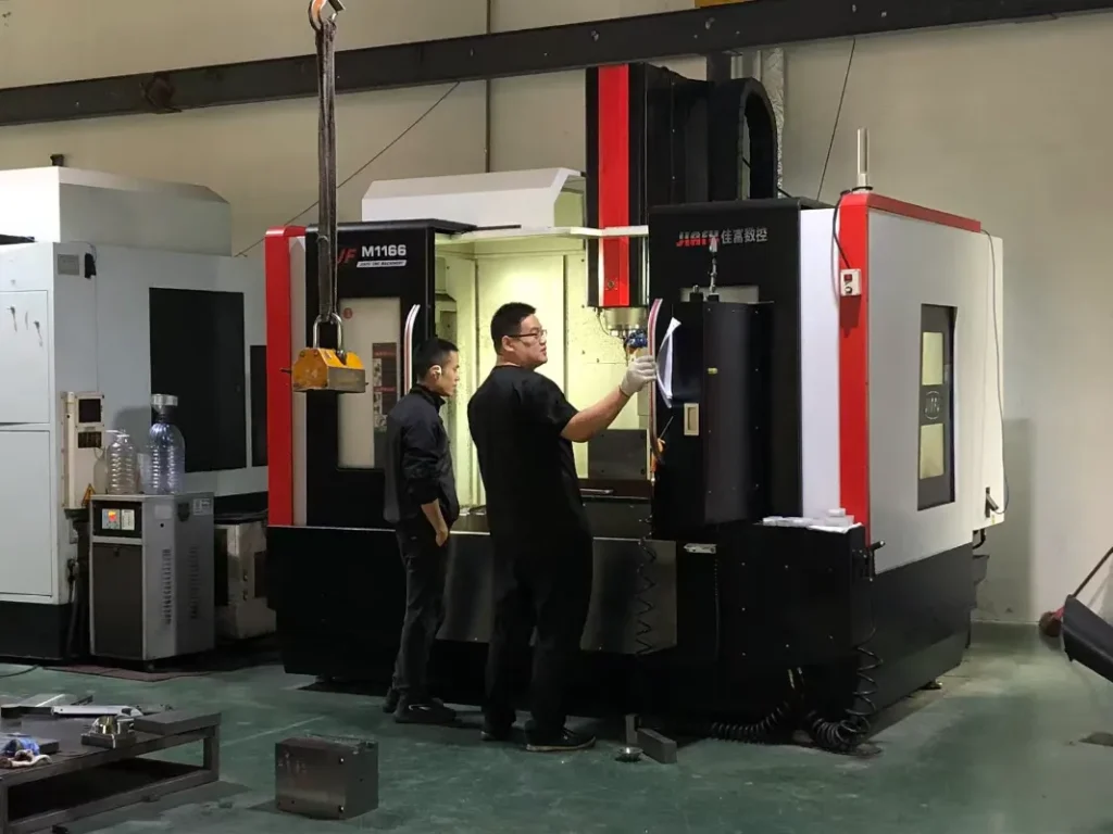 Injection molding machine with mold open showing ejected plastic hair clip parts