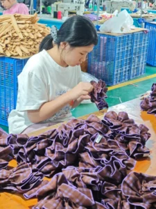 Hair accessories OEM production line showing injection moulded claw clip components at a manufacturing facility