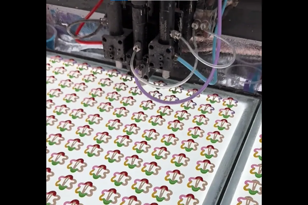Epoxy drip coating machine filling color into hair clip pieces on a production sheet