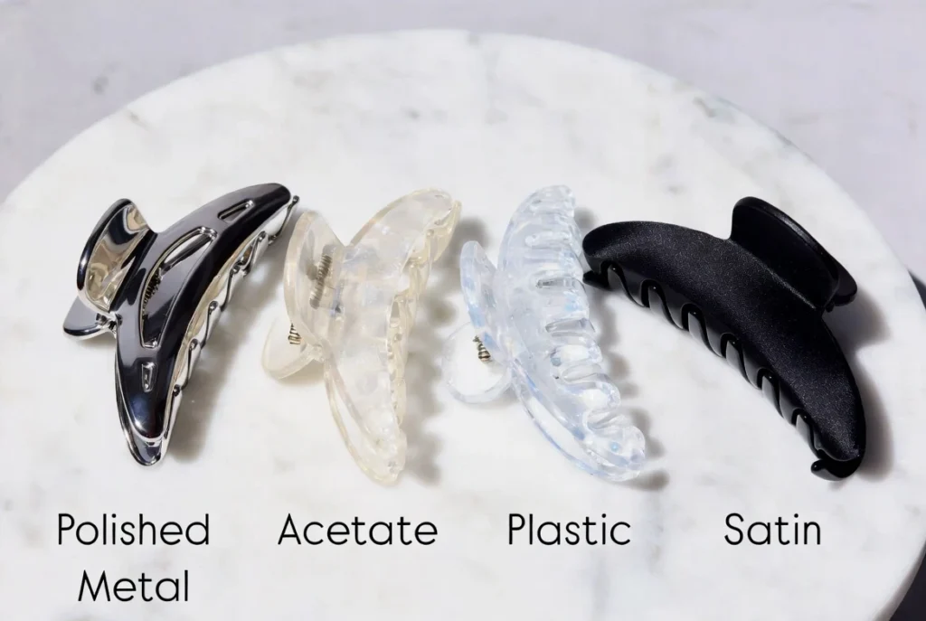 Comparison of polished metal, acetate, plastic and satin claw clips side by side