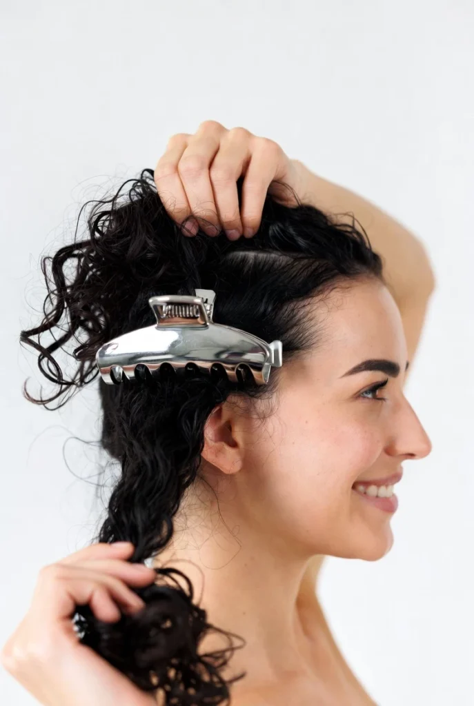 Woman gently applying metal claw clip without pulling or damage