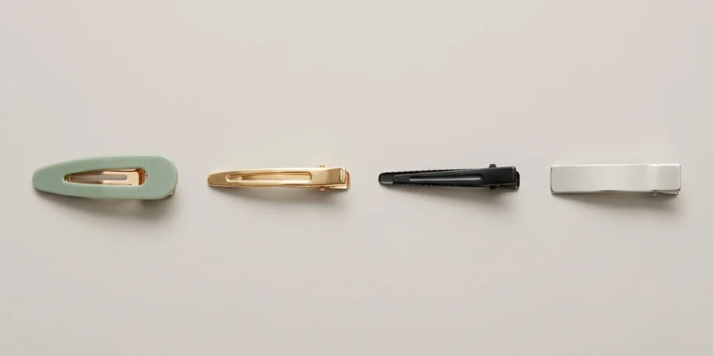 Four flat hair clip types displayed in a row: snap barrette, French clip, alligator clip and no-crease flat clip