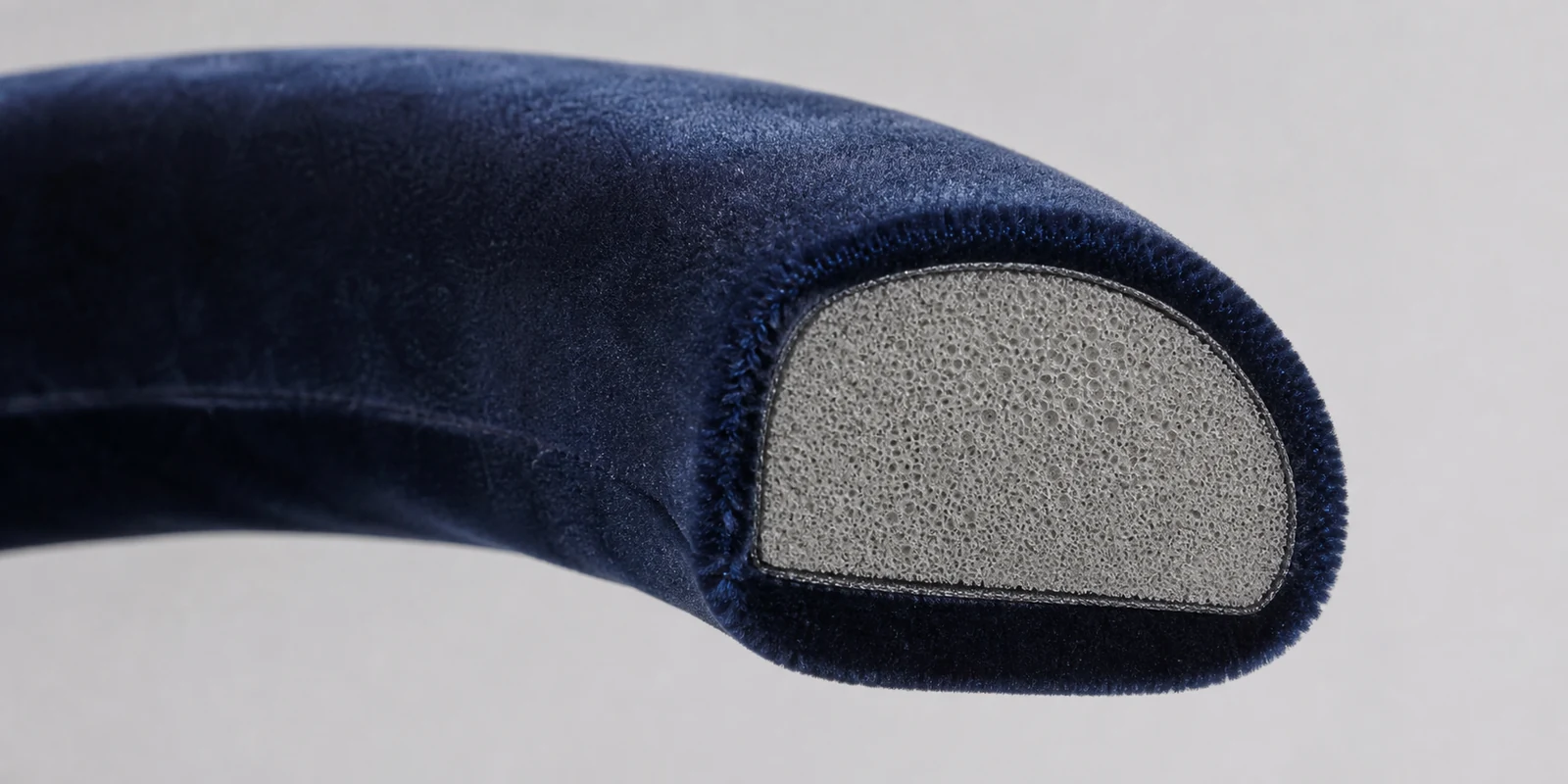Cross-section detail of a padded headband showing foam core and fabric covering