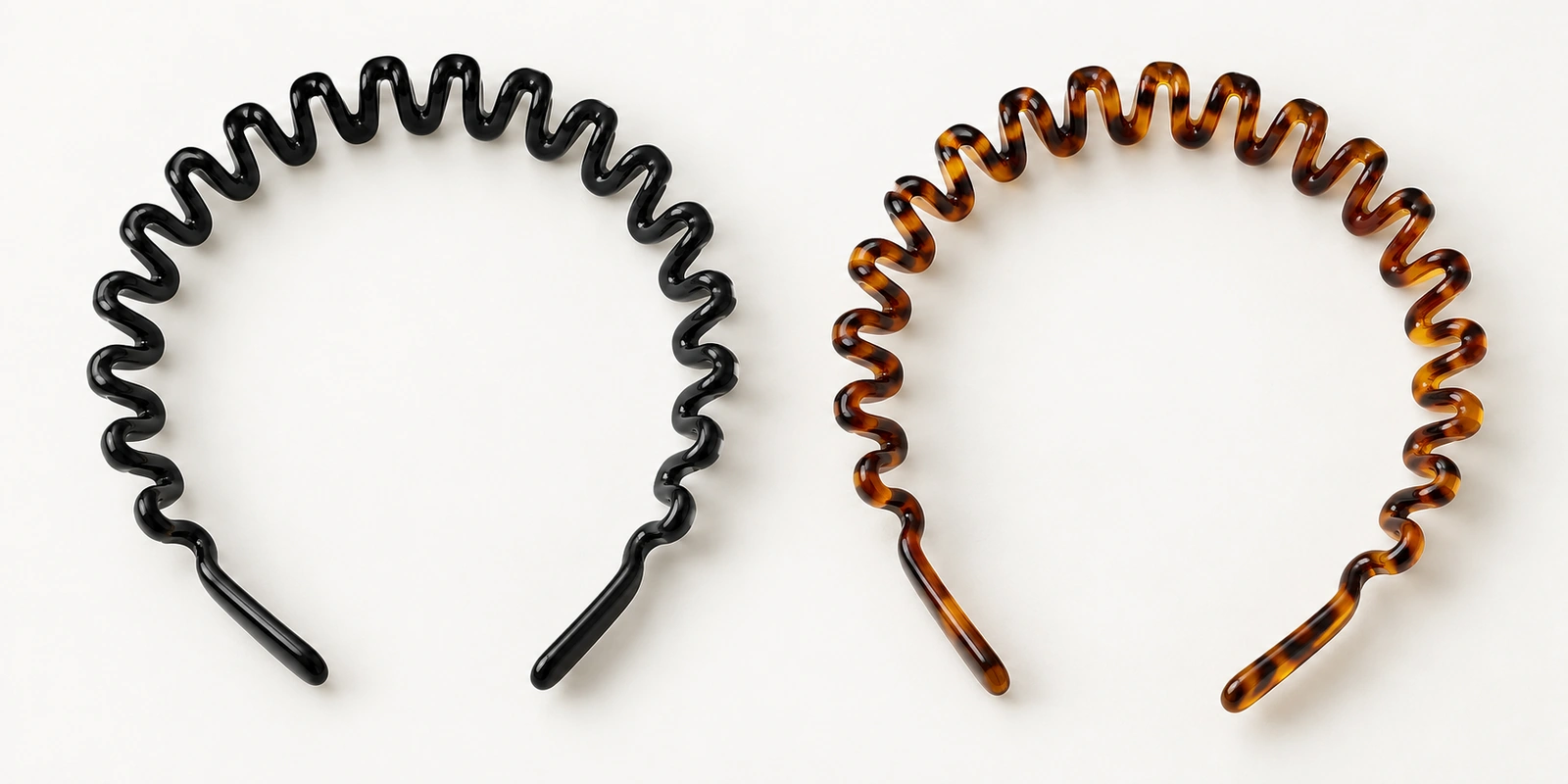 Comb headbands with zigzag teeth in black and tortoise plastic on a neutral background